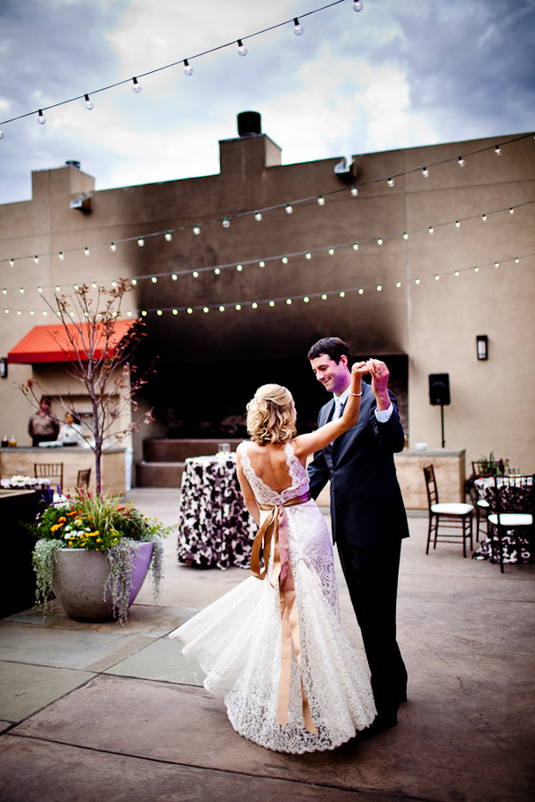 the happy couple dancing at the reception - bride is wearing a beautiful champagne lace dress with gold sash - photo by New Mexico based wedding photographers Twin Lens